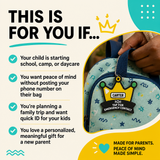 A hand holds a blue backpack with a black, yellow, and green crown-shaped keychain attached, displaying "CARTER" and "TAP FOR EMERGENCY CONTACT."